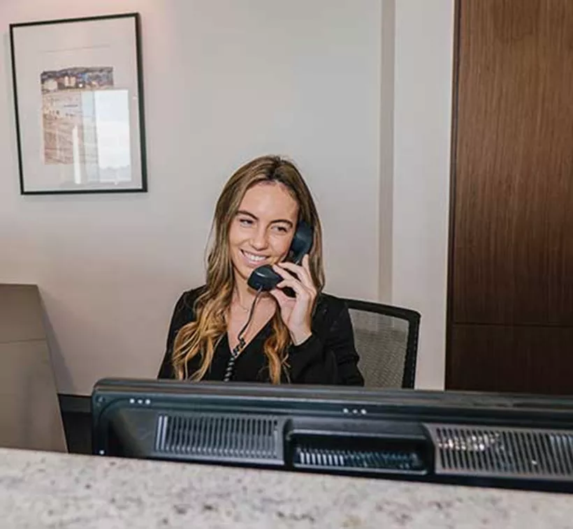 A dedicated Servcorp receptionist answering calls with professionalism and warmth