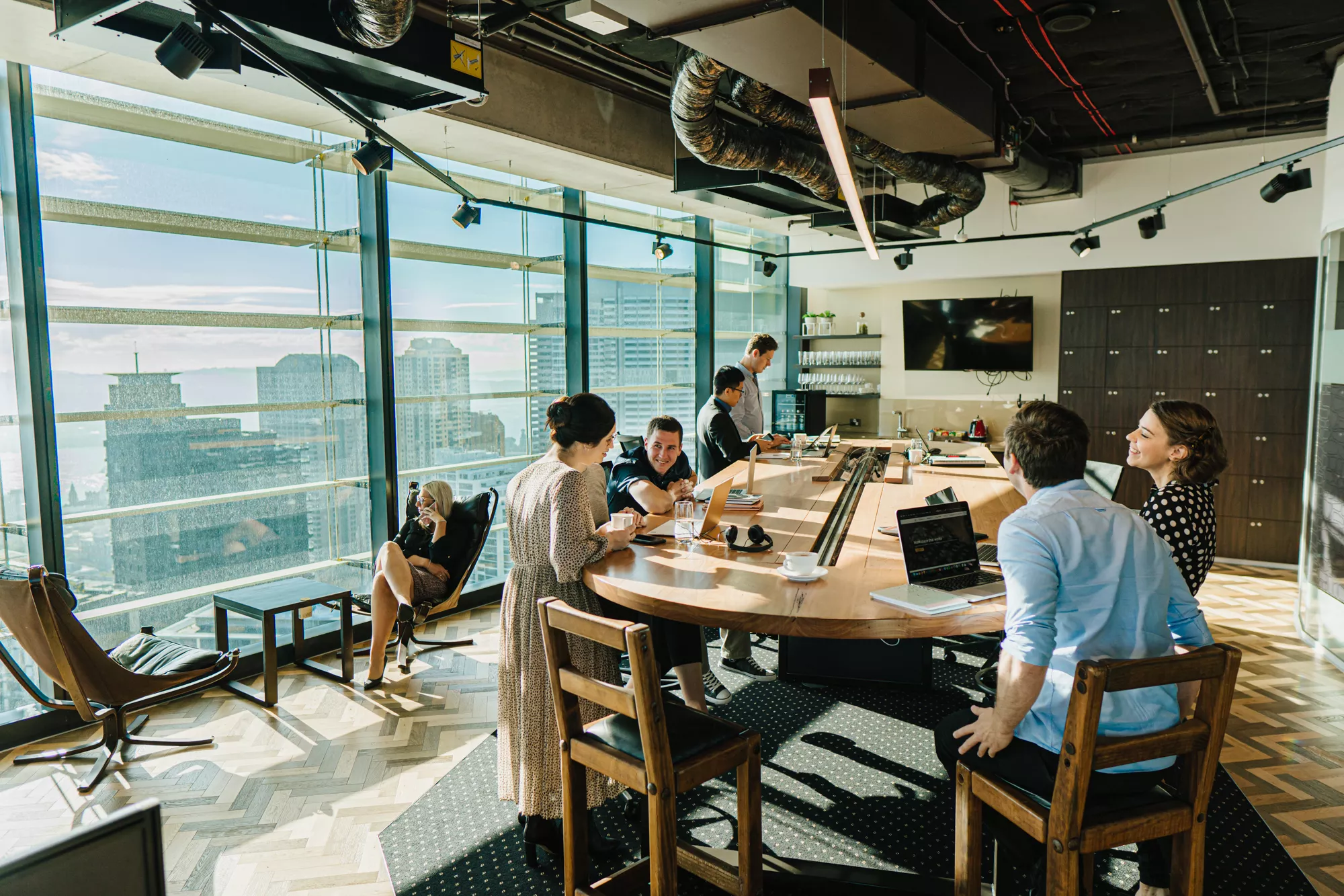 Close up on people working in a coworking space on a large table and impressive view in Barangaroo, tower 1