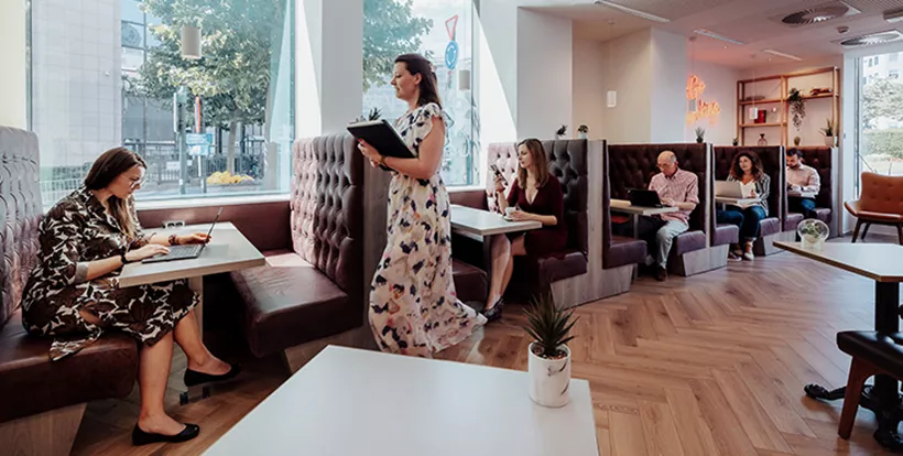 Coworking lounge at Servcorp Bastion Tower, Leopold Quarter—natural light, and a vibrant shared workspace in Brussels