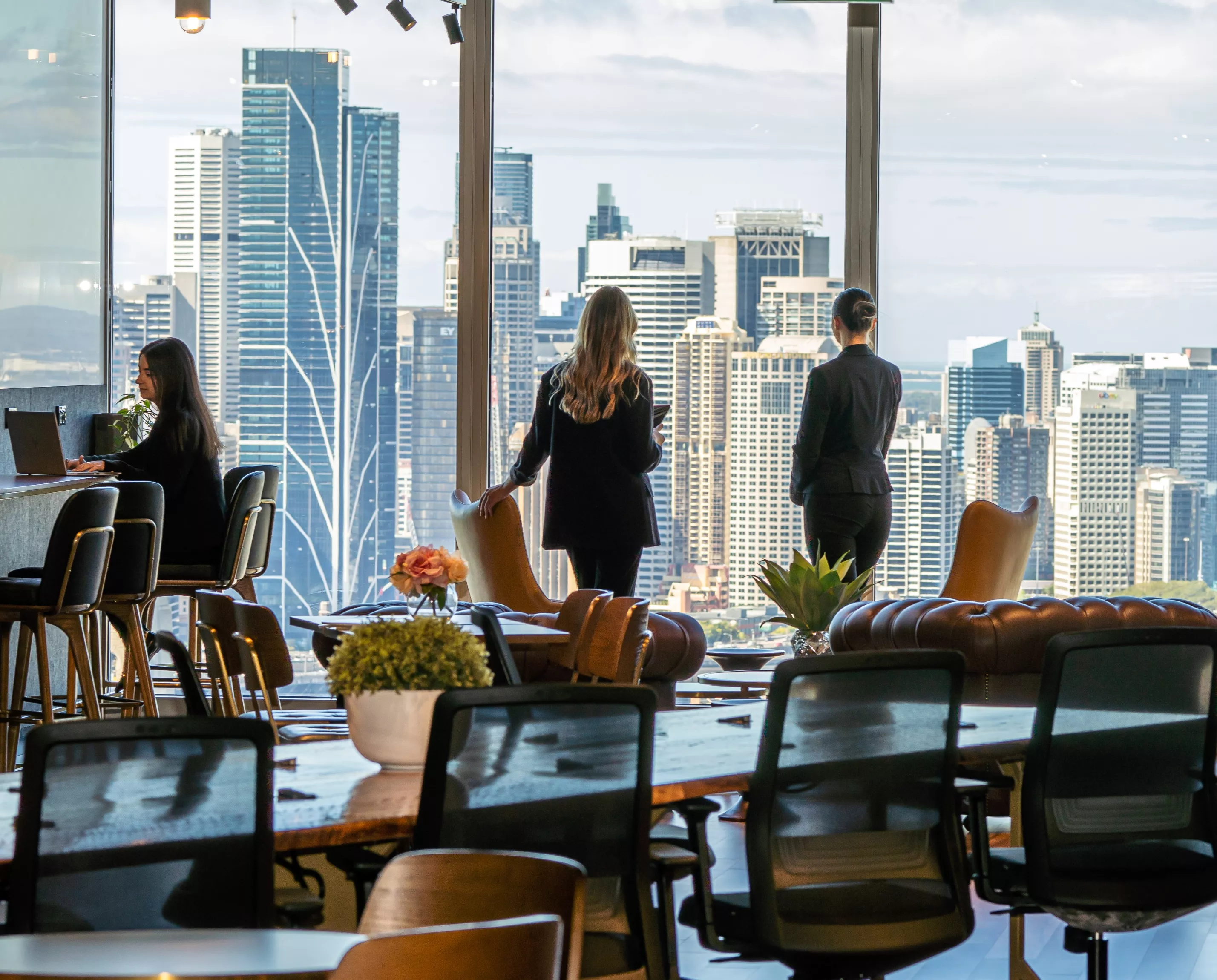 Two clients overlooking the view in the Servcorp 100 Mount Street coworking space