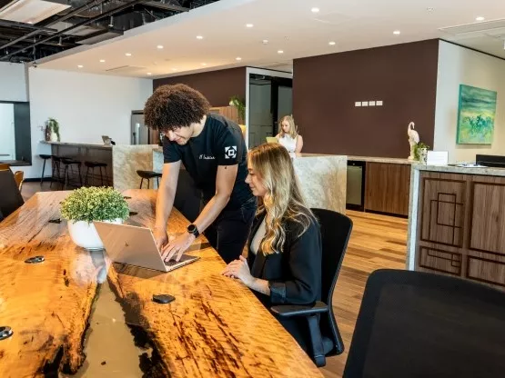 Skilled IT member helping out a client in need at the modern coworking space at Servcorp 100 Mount Street