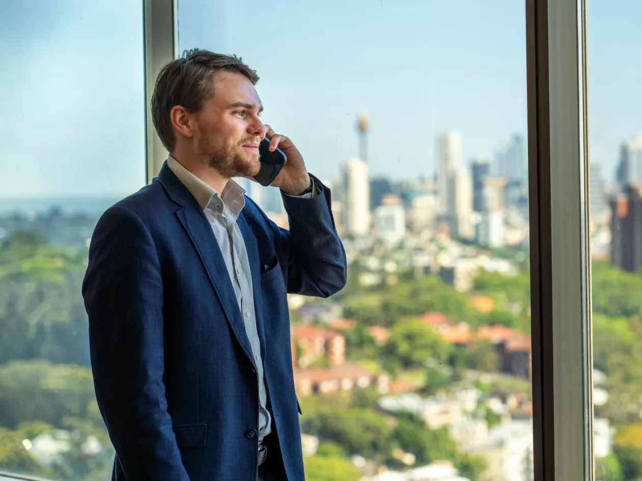Clients conversing on the phone at a modern co-working space with a nice view at Servcorp Westfield Tower 2