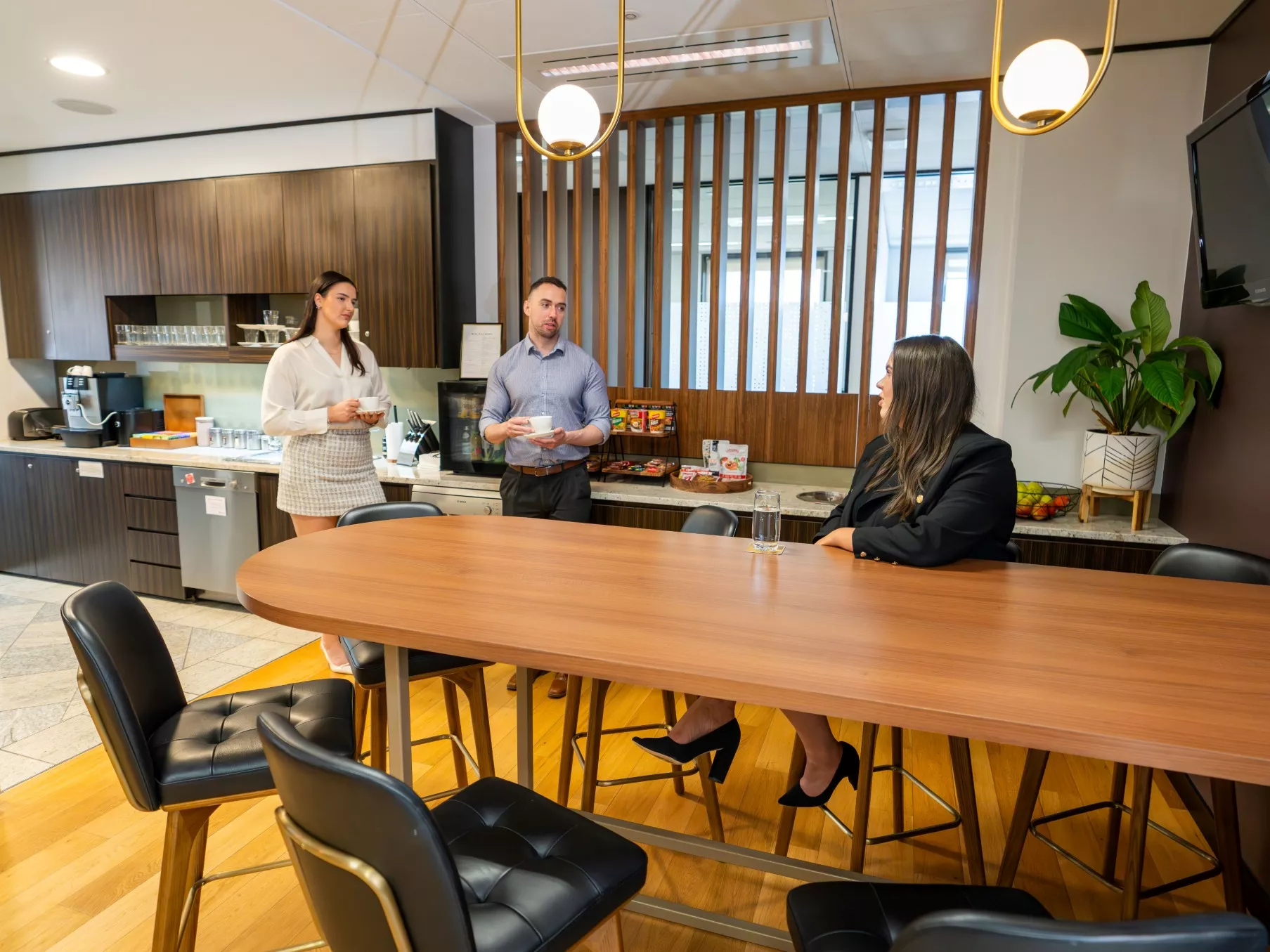 Clients enjoying the fully stocked kitchen and coffee break in Servcorp Reserve Bank Building, Hobart